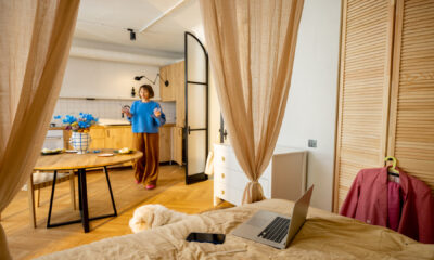 women inbeautiful studio apartment with predominantly beige colours