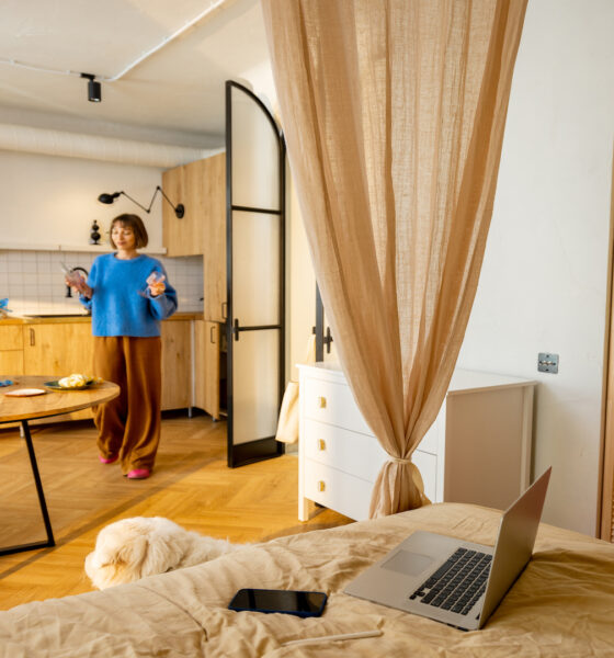 women inbeautiful studio apartment with predominantly beige colours