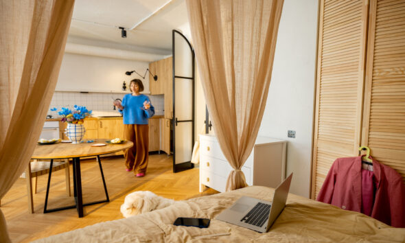 women inbeautiful studio apartment with predominantly beige colours