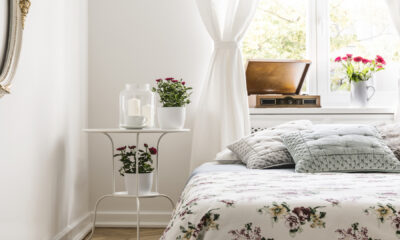 Bedroom with large window and floral pattern cover on the bed