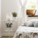 Bedroom with large window and floral pattern cover on the bed