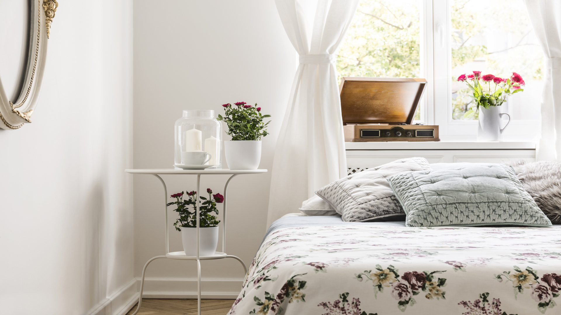 Bedroom with large window and floral pattern cover on the bed