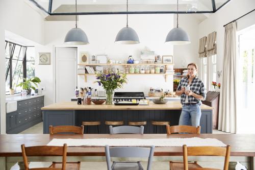 Young woman standing in an open plan kitchen dining room